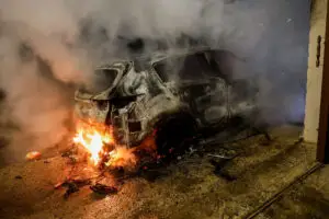 A car burns after an attack by Jewish settlers on the